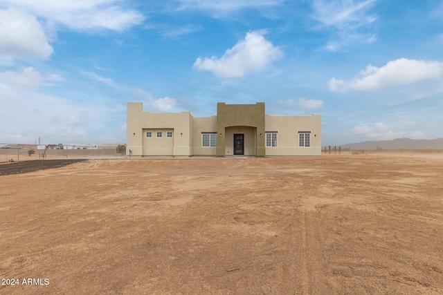 pueblo revival-style home featuring a mountain view