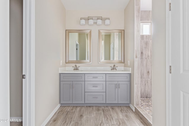 bathroom featuring vanity, hardwood / wood-style flooring, and a shower