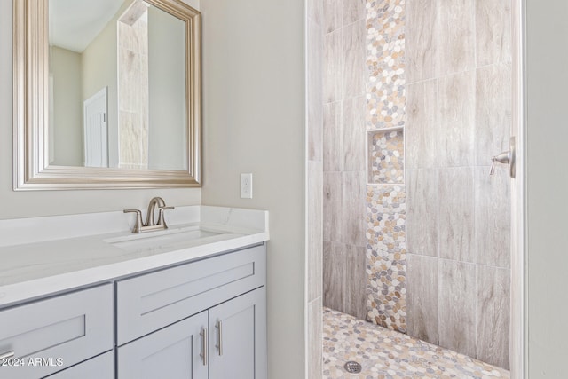 bathroom featuring vanity and a tile shower