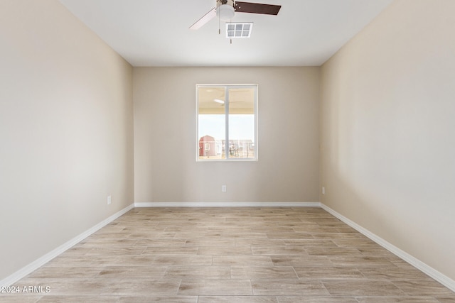 spare room with light hardwood / wood-style flooring and ceiling fan