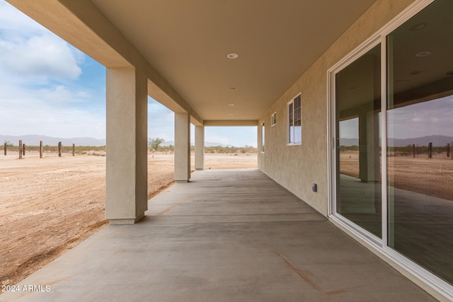 view of patio featuring a rural view and a mountain view