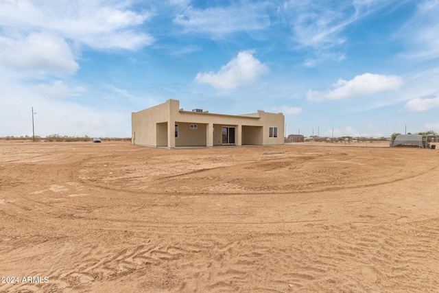 rear view of house with a rural view