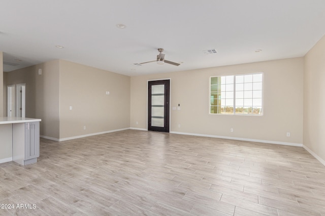 spare room with ceiling fan and light hardwood / wood-style flooring