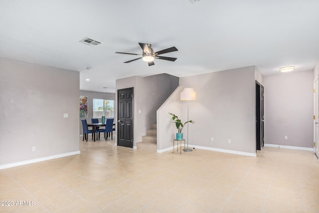 tiled spare room featuring ceiling fan