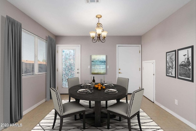 dining area featuring a notable chandelier and light tile patterned floors