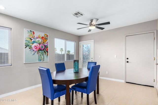 tiled dining space featuring ceiling fan