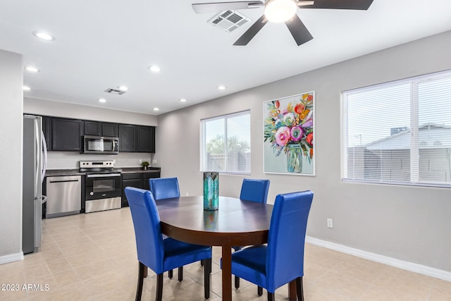 dining space with ceiling fan and light tile patterned floors