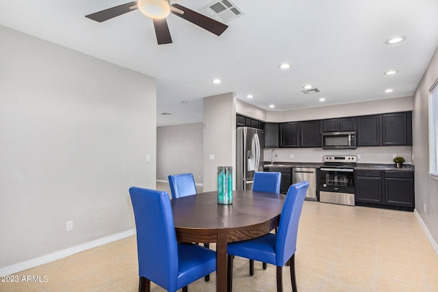 dining room with light tile patterned flooring, ceiling fan, and sink