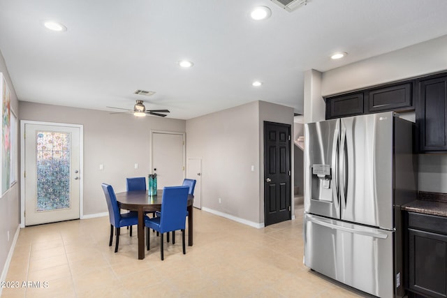 dining space with ceiling fan and light tile patterned flooring