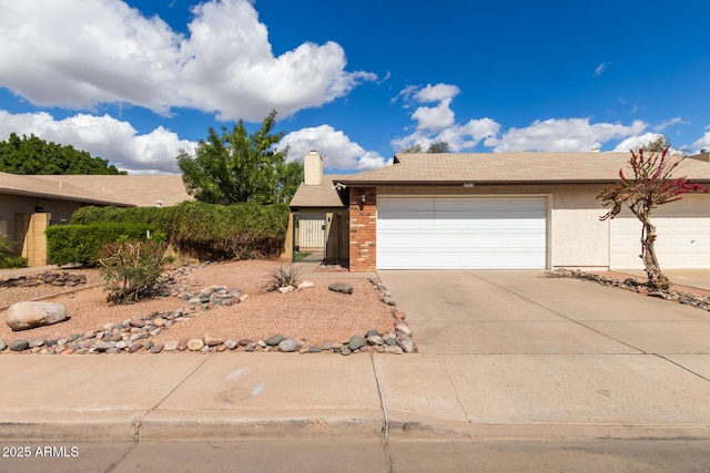 view of front of home featuring concrete driveway, a chimney, and an attached garage