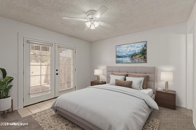 bedroom featuring ceiling fan, access to exterior, a textured ceiling, french doors, and light tile patterned flooring