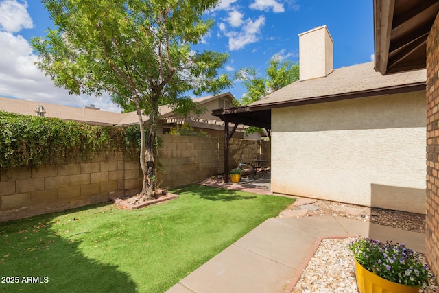 view of yard with fence and a patio