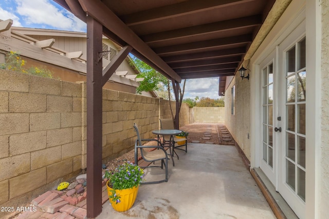 view of patio with french doors and a fenced backyard