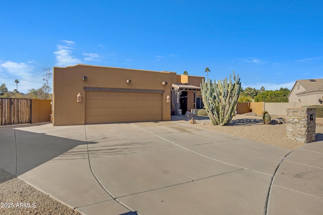 pueblo-style house with a garage