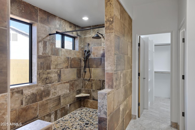 bathroom featuring a tile shower