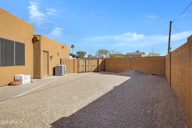 view of yard with a patio and central AC unit