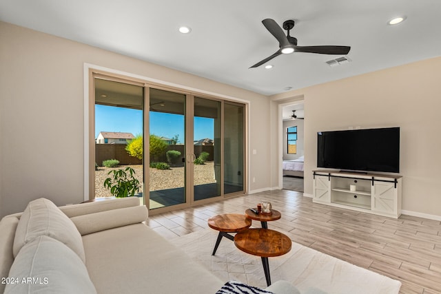 living room with ceiling fan and light hardwood / wood-style floors