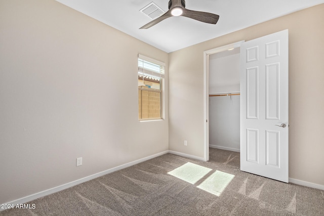 unfurnished bedroom featuring ceiling fan, carpet floors, and a closet