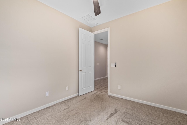 carpeted empty room with ceiling fan