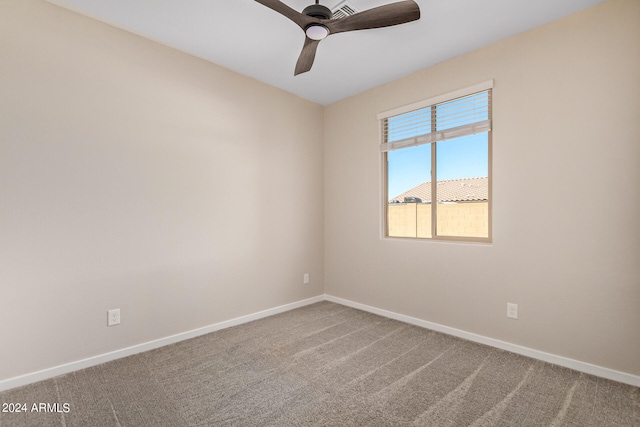 spare room featuring carpet flooring and ceiling fan