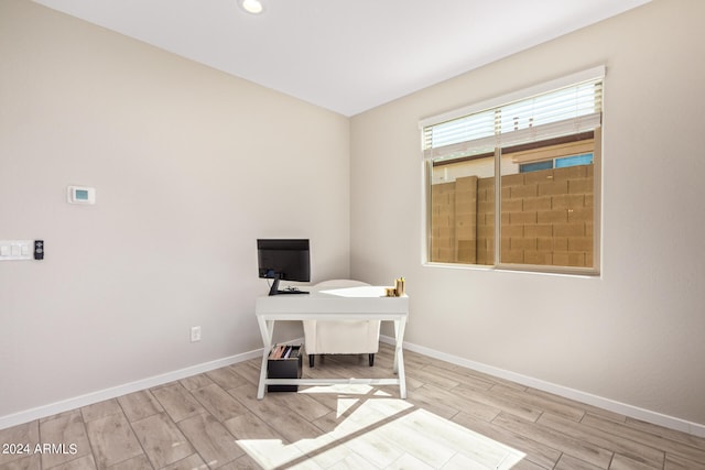 unfurnished office featuring light hardwood / wood-style floors