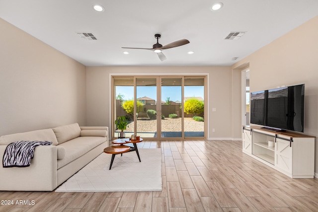 living room featuring ceiling fan and light hardwood / wood-style floors