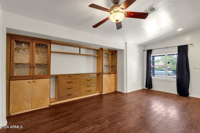 unfurnished living room with ceiling fan, dark hardwood / wood-style flooring, lofted ceiling, and a textured ceiling