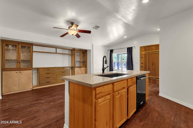 kitchen featuring vaulted ceiling, dark wood-type flooring, sink, black dishwasher, and an island with sink