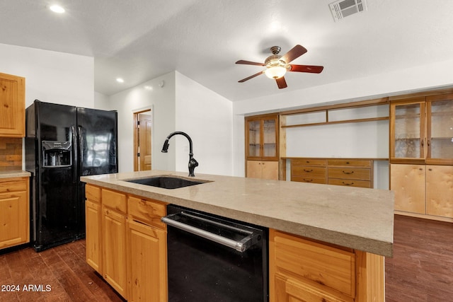 kitchen with dark hardwood / wood-style flooring, tasteful backsplash, a kitchen island with sink, sink, and black appliances