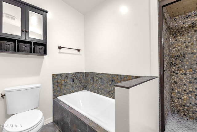 bathroom featuring shower with separate bathtub and toilet