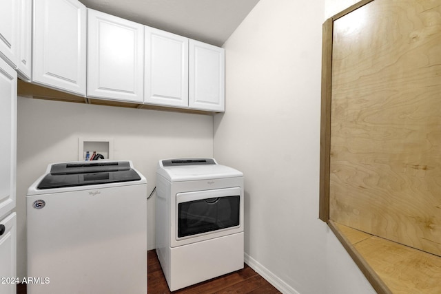 laundry area with dark hardwood / wood-style floors, cabinets, and separate washer and dryer