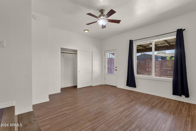 unfurnished bedroom with hardwood / wood-style floors, ceiling fan, and a closet