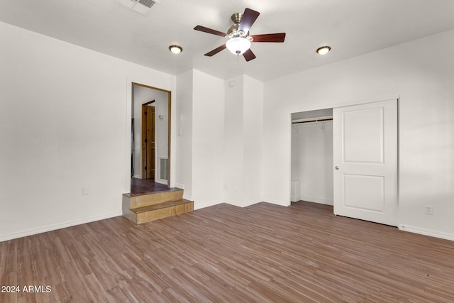 unfurnished bedroom featuring a closet, ceiling fan, and hardwood / wood-style floors