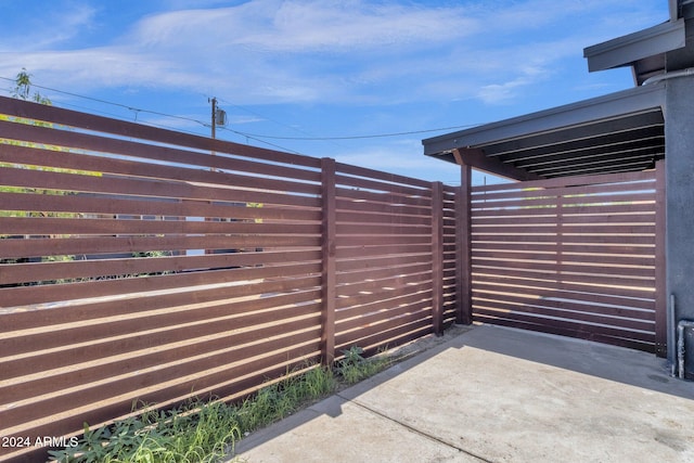 view of gate featuring a patio