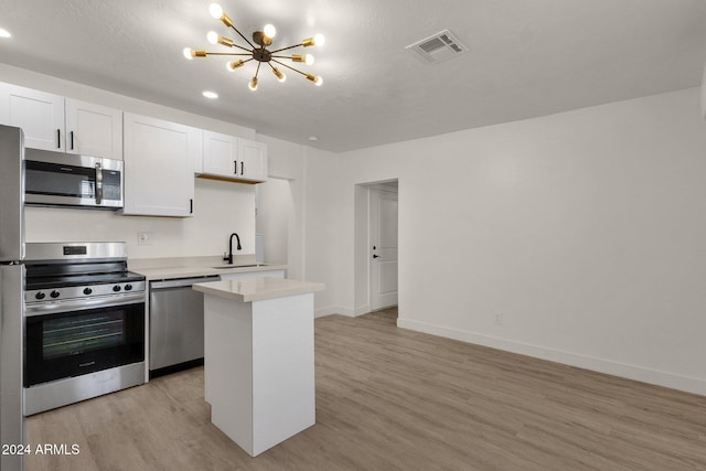 kitchen featuring white cabinets, light hardwood / wood-style floors, and appliances with stainless steel finishes