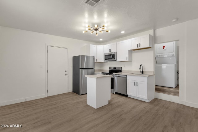 kitchen featuring a center island, white cabinets, stainless steel appliances, and light hardwood / wood-style floors