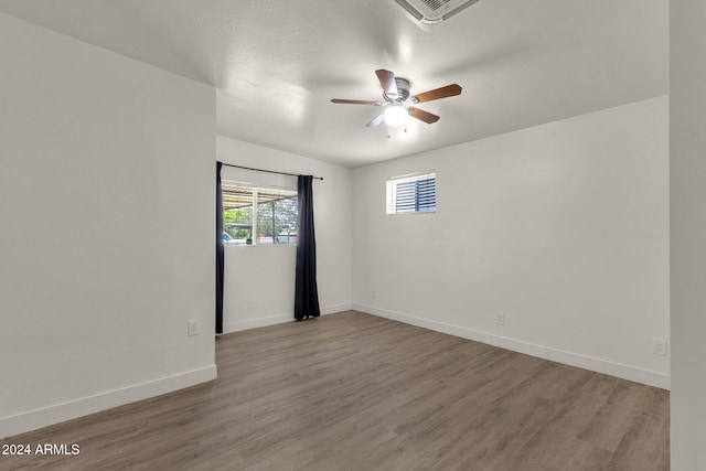 spare room featuring light wood-type flooring and ceiling fan