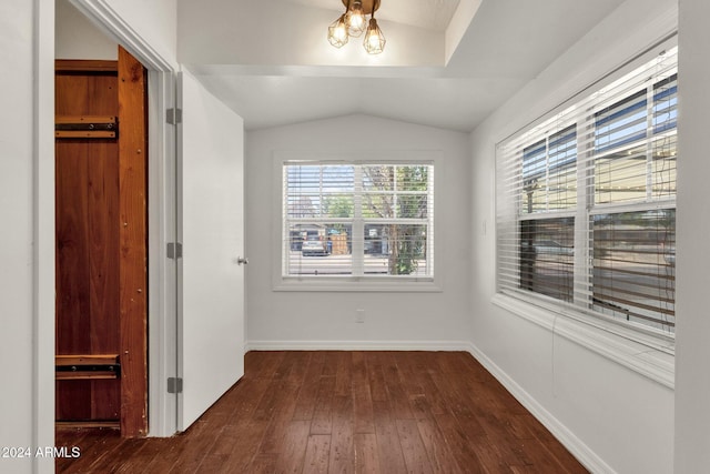 hallway featuring vaulted ceiling and dark wood-type flooring