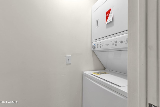 washroom featuring stacked washer and dryer