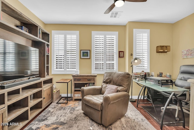 office area featuring ceiling fan and dark hardwood / wood-style flooring