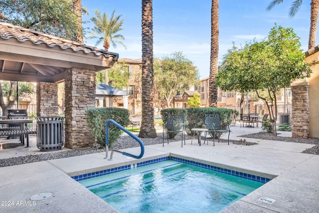 view of swimming pool with a gazebo, a hot tub, and a patio