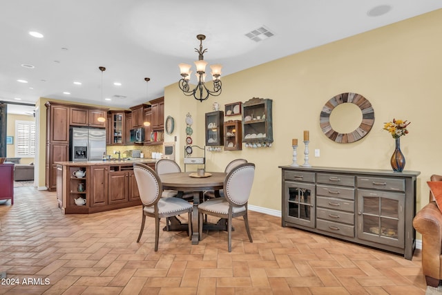 dining space with a chandelier and light parquet flooring