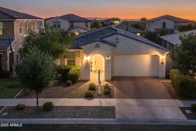 4346 S Synapse Dr, Mesa, AZ 85212 - mediterranean / spanish home featuring driveway, stucco siding, a garage, a residential view, and a tile roof