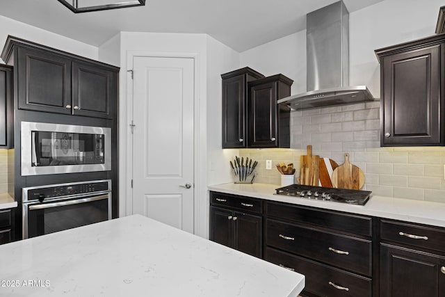 4346 S Synapse Dr, Mesa, AZ 85212 - kitchen with appliances with stainless steel finishes, wall chimney exhaust hood, tasteful backsplash, and light stone countertops