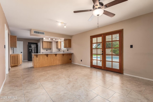 3010 E Cortez St, Phoenix, AZ 85028 - kitchen with refrigerator with ice dispenser, a peninsula, french doors, baseboards, and a kitchen breakfast bar