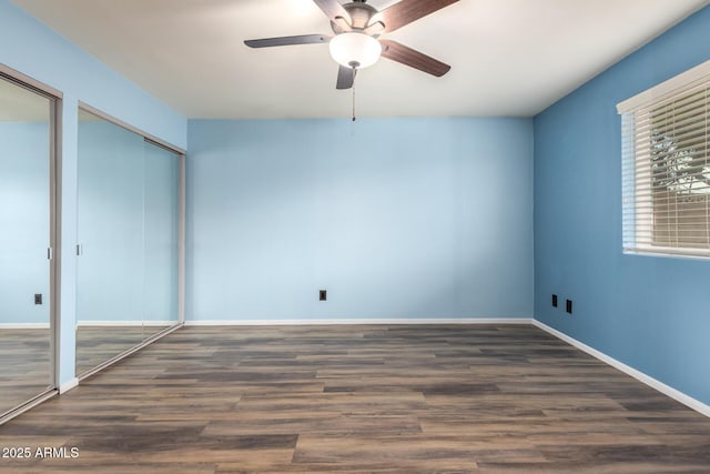 3010 E Cortez St, Phoenix, AZ 85028 - unfurnished bedroom featuring multiple closets, wood finished floors, baseboards, and a ceiling fan