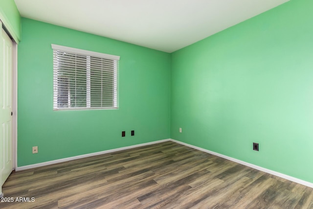 3010 E Cortez St, Phoenix, AZ 85028 - unfurnished bedroom with a closet, wood finished floors, and baseboards