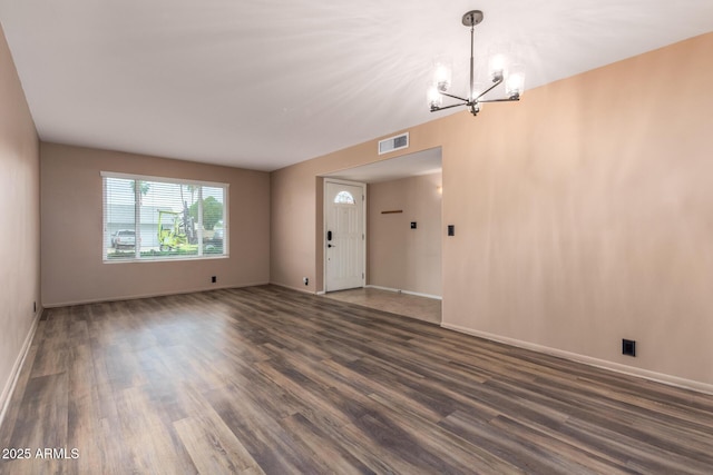 3010 E Cortez St, Phoenix, AZ 85028 - unfurnished living room featuring a chandelier, wood finished floors, and baseboards