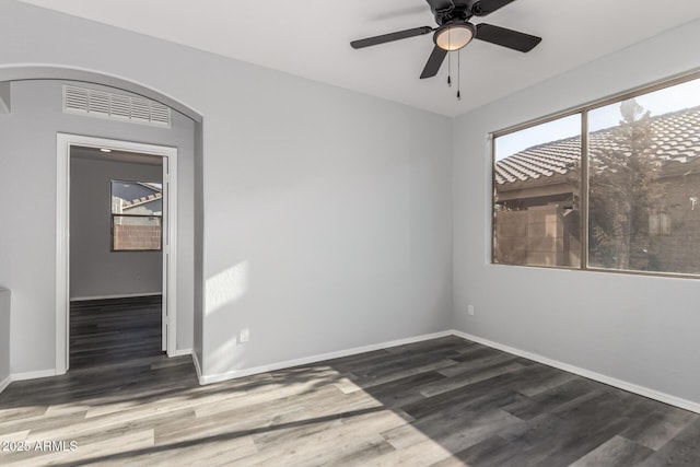 20919 E Desert Hills Blvd, Queen Creek, AZ 85142 - empty room featuring wood finished floors, arched walkways, and ceiling fan
