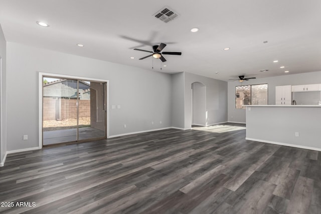 20919 E Desert Hills Blvd, Queen Creek, AZ 85142 - unfurnished living room with ceiling fan, arched walkways, recessed lighting, and dark wood-type flooring